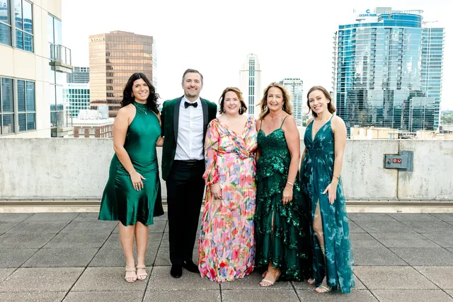 Guests posing together on the rooftop at the 2025 Goodness Gala