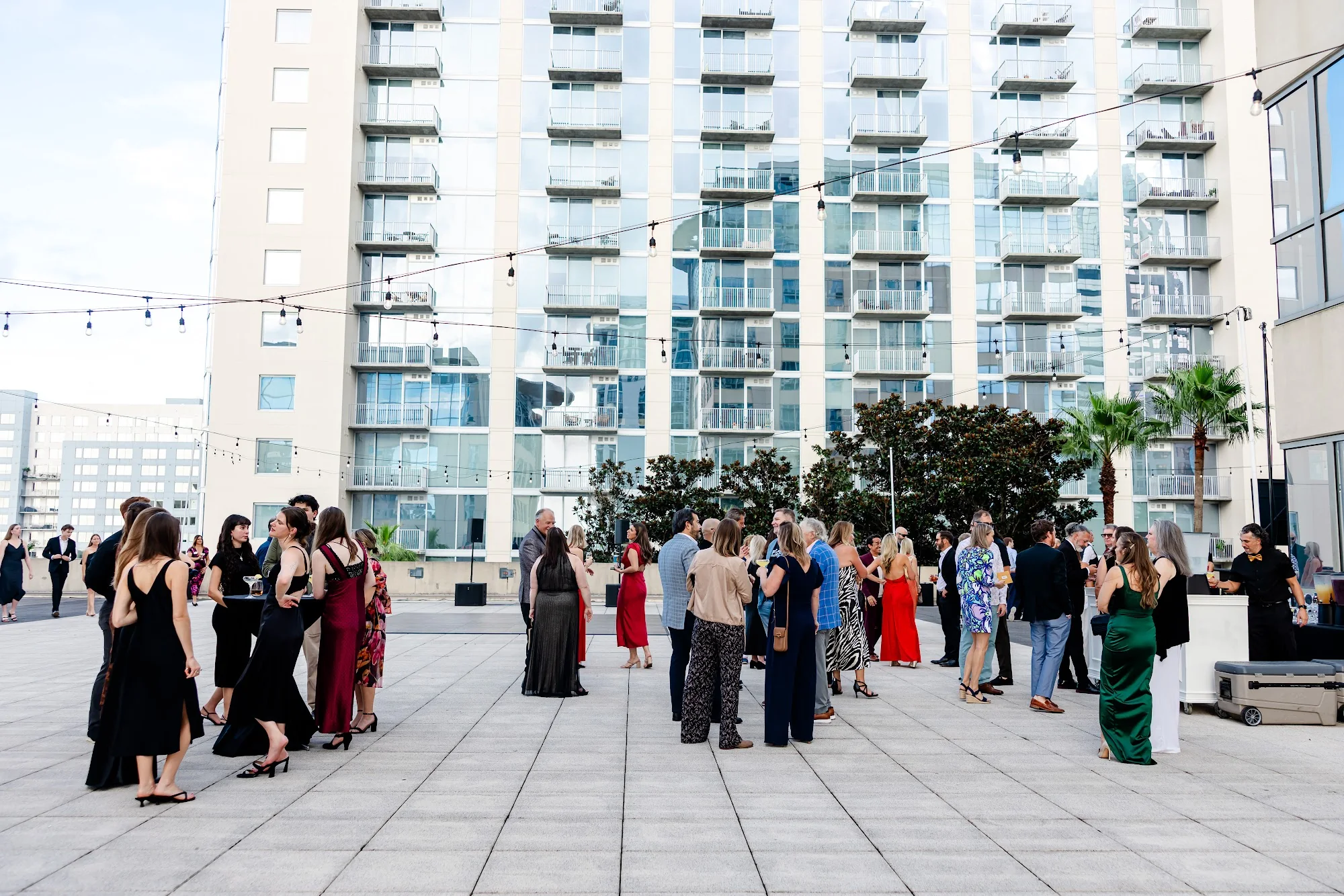 Guests mingling on the rooftop beneath string lights at the 2026 Goodness Gala